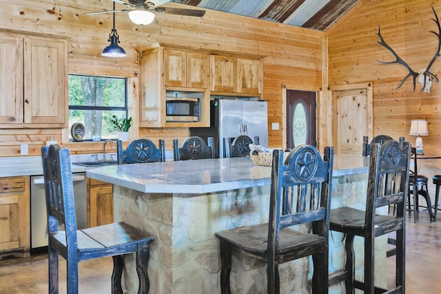 kitchen with concrete flooring, light brown cabinets, stainless steel appliances, and lofted ceiling