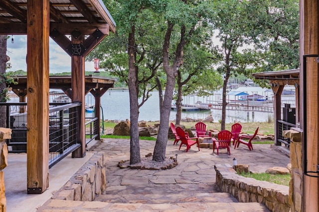 view of patio / terrace featuring a water view and an outdoor fire pit