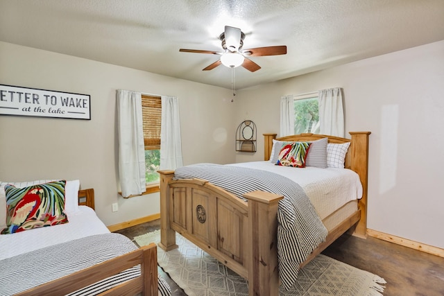 bedroom with ceiling fan and a textured ceiling