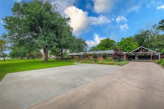 view of home's community with a carport and a lawn