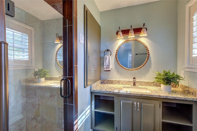 bathroom with vanity and a shower with shower door