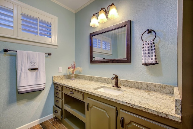 bathroom with hardwood / wood-style flooring, vanity, and ornamental molding