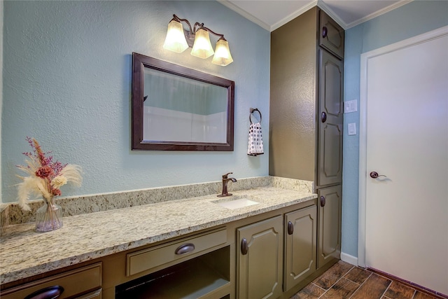 bathroom with hardwood / wood-style floors, vanity, and ornamental molding