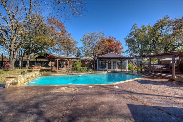 view of pool with a pergola, a gazebo, a patio, an outbuilding, and pool water feature