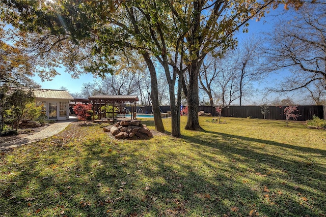 view of yard with a fenced in pool