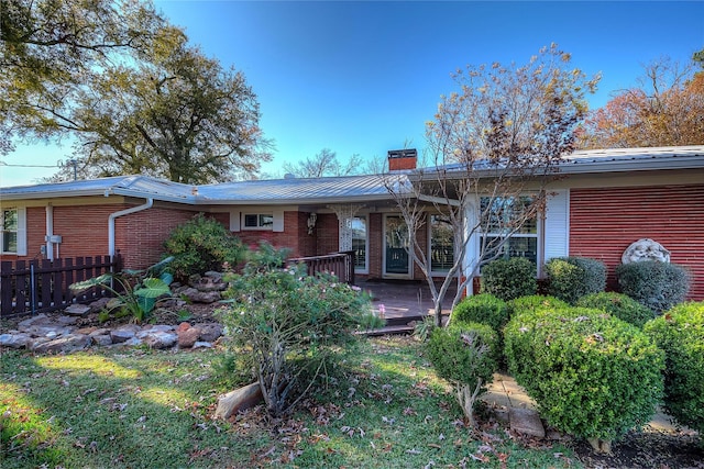 rear view of property with a yard