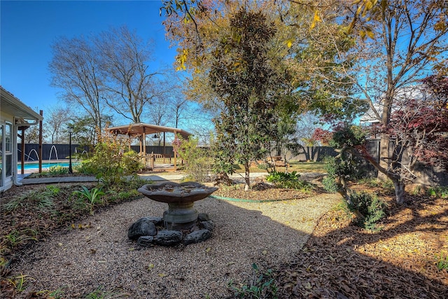 view of yard with a fenced in pool and a gazebo