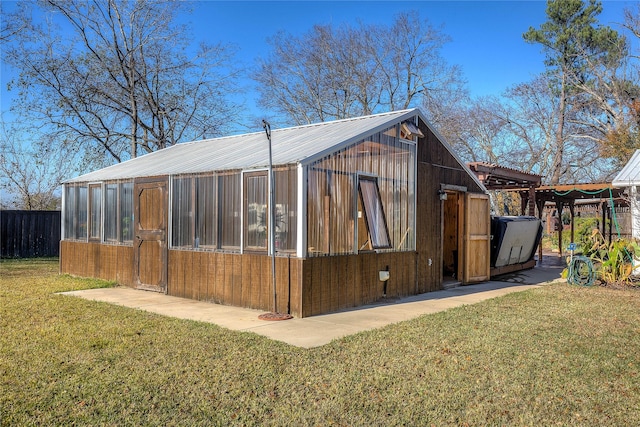 view of property exterior featuring an outbuilding and a yard