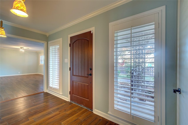 foyer entrance with dark wood-type flooring and ornamental molding