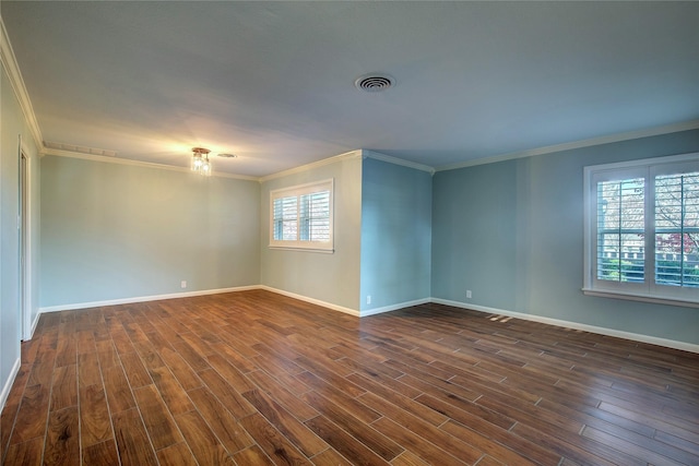 empty room featuring dark hardwood / wood-style floors and ornamental molding