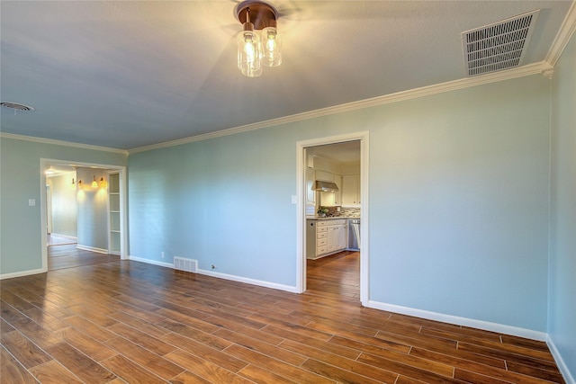 empty room featuring wood-type flooring and ornamental molding