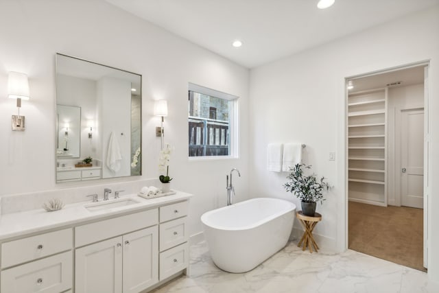 bathroom with vanity and a bath