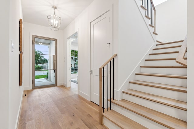 foyer entrance featuring a chandelier and light hardwood / wood-style flooring