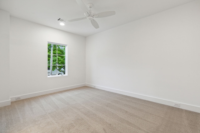 unfurnished room with light colored carpet and ceiling fan