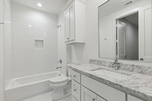 full bathroom with vanity, tiled shower / bath combo, and toilet