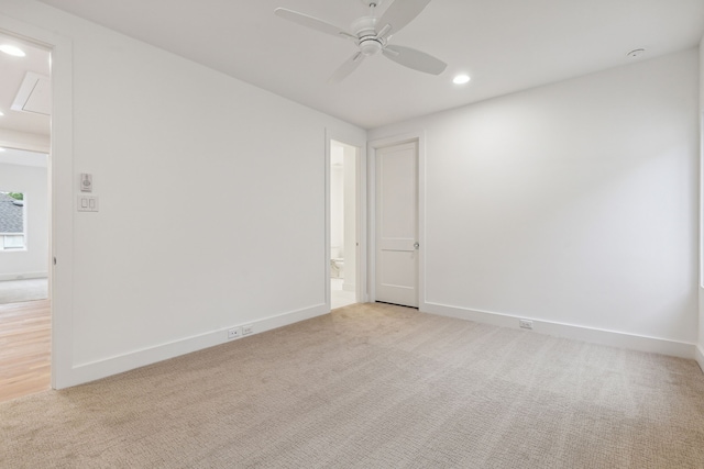 carpeted spare room with ceiling fan