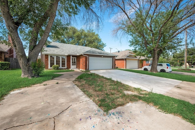 ranch-style home featuring a garage and a front lawn