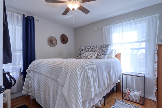 bedroom with hardwood / wood-style flooring and ceiling fan