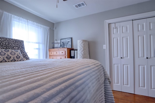 bedroom featuring hardwood / wood-style flooring, a closet, and ceiling fan