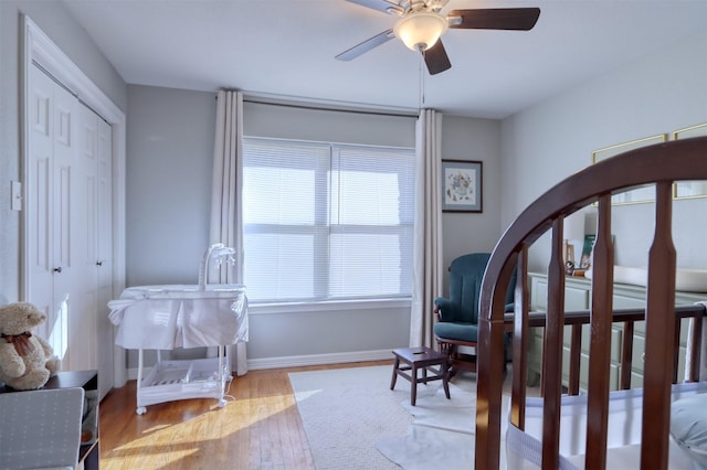 bedroom with ceiling fan, a closet, and light wood-type flooring