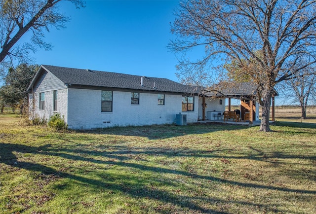 back of property with a lawn and central AC unit