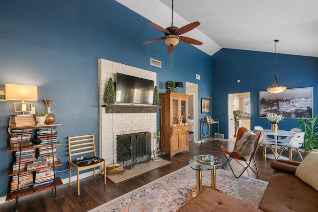 living room with ceiling fan, a brick fireplace, high vaulted ceiling, and dark hardwood / wood-style flooring