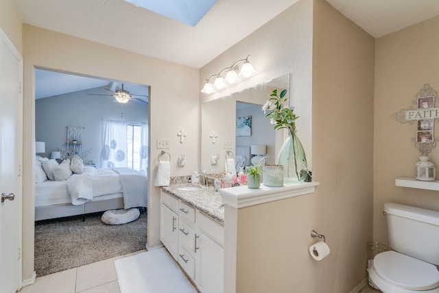 kitchen with white cabinetry, sink, light stone counters, light tile patterned floors, and appliances with stainless steel finishes