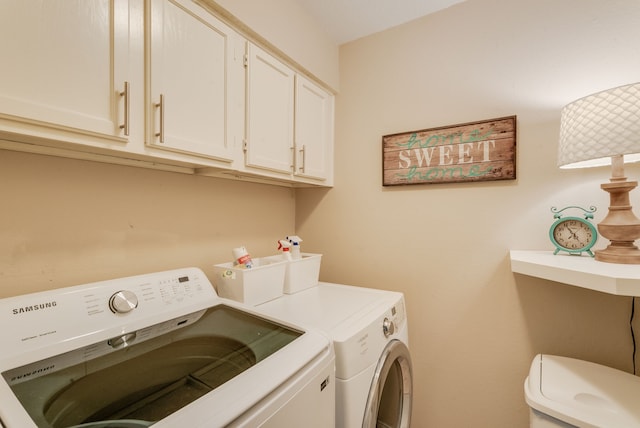 washroom featuring separate washer and dryer and cabinets