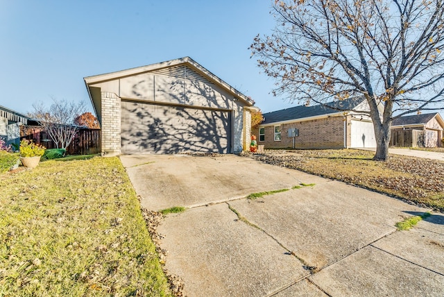 ranch-style home with a garage and a front lawn