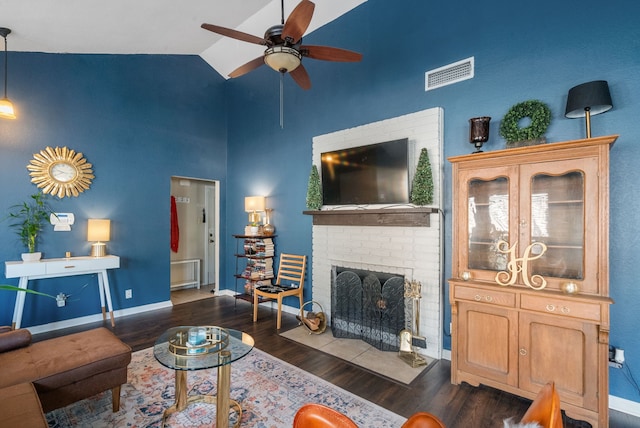 living room with ceiling fan, high vaulted ceiling, a fireplace, and dark hardwood / wood-style flooring