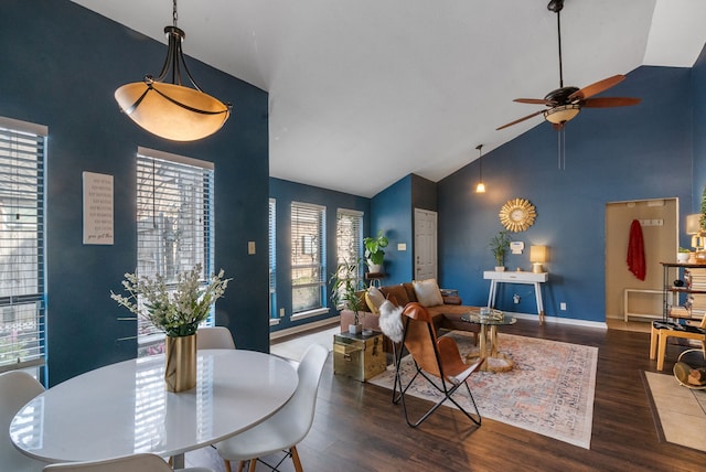 living room featuring dark hardwood / wood-style flooring, high vaulted ceiling, and ceiling fan