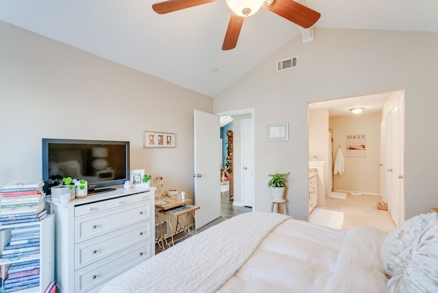 tiled bedroom featuring ceiling fan, high vaulted ceiling, and ensuite bath