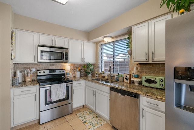 kitchen featuring stainless steel appliances, sink, and white cabinets