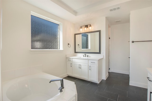 bathroom with vanity, tiled bath, and tile patterned flooring