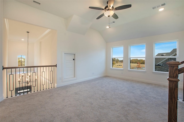 unfurnished living room with carpet floors, ceiling fan with notable chandelier, and vaulted ceiling