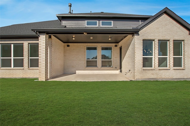 rear view of house featuring a patio and a lawn