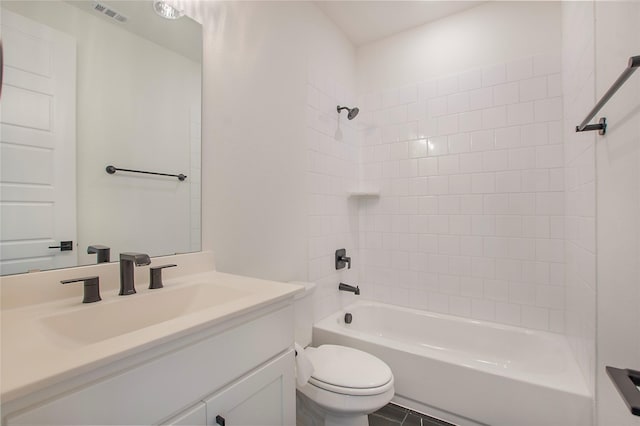 full bathroom featuring tiled shower / bath combo, vanity, and toilet