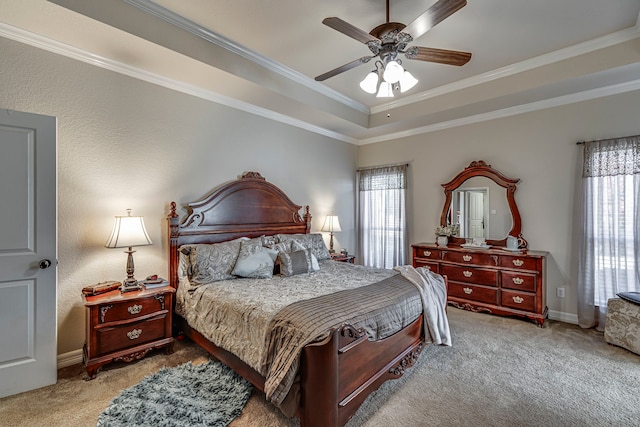 bedroom with light carpet, a tray ceiling, ceiling fan, and ornamental molding