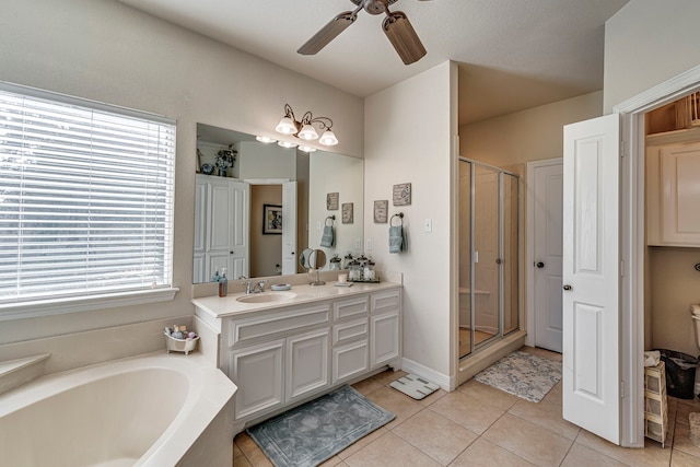 bathroom featuring tile patterned flooring, shower with separate bathtub, vanity, and a healthy amount of sunlight