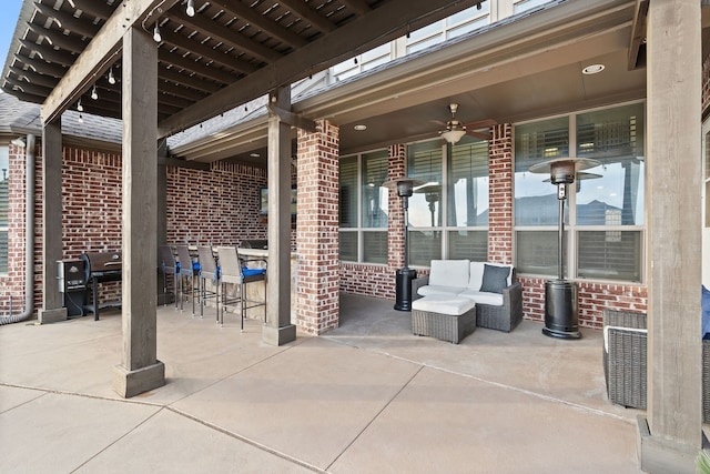 view of patio with exterior bar and ceiling fan