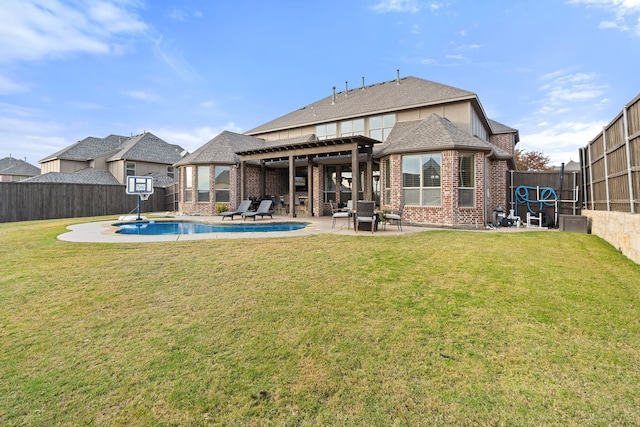 back of house featuring a pergola, a yard, a patio, and a fenced in pool