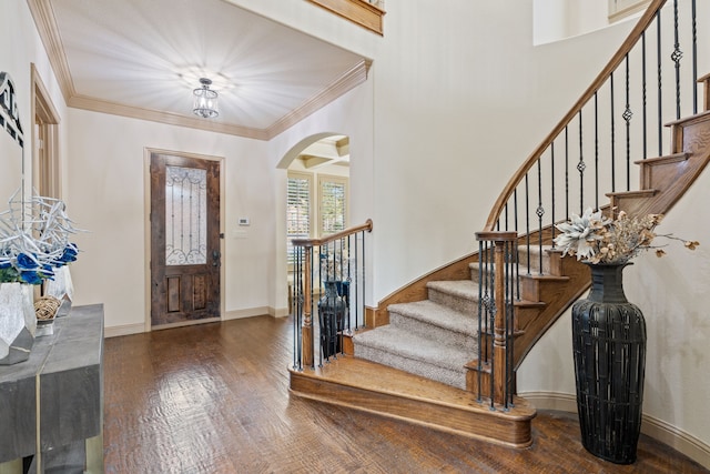 foyer featuring wood-type flooring and ornamental molding