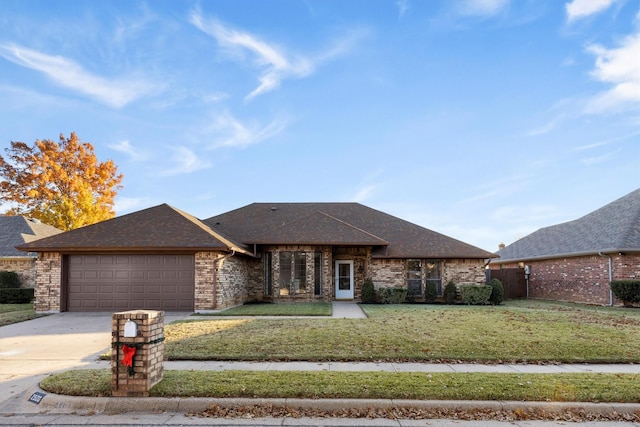 view of front facade with a garage and a front lawn