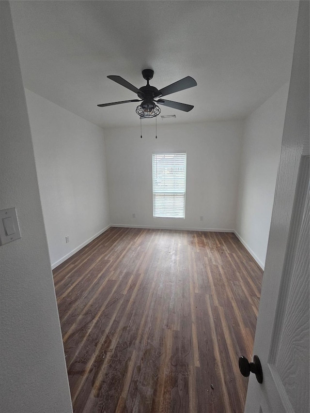 spare room featuring ceiling fan and dark hardwood / wood-style flooring