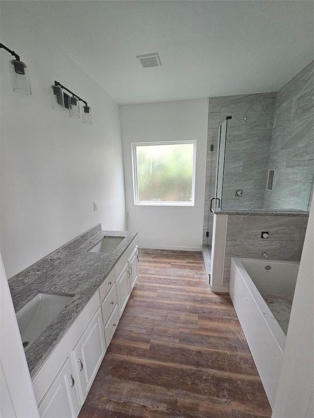 bathroom featuring hardwood / wood-style floors, vanity, and independent shower and bath