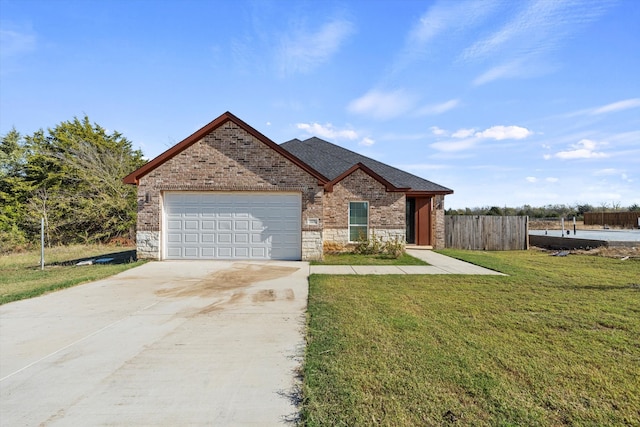 ranch-style home featuring fence, a front lawn, an attached garage, driveway, and stone siding