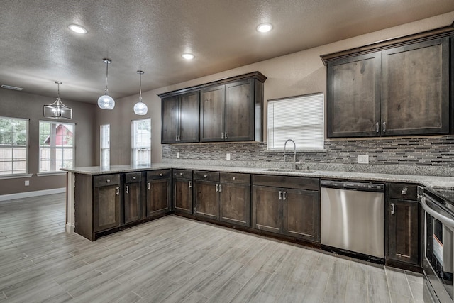 kitchen with hanging light fixtures, dishwasher, sink, and dark brown cabinetry