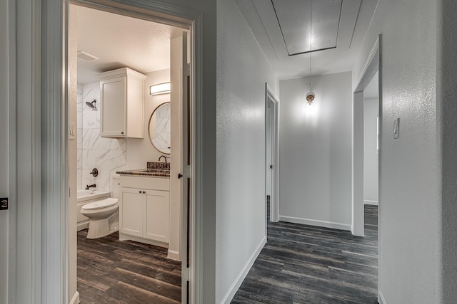 hallway featuring sink and dark hardwood / wood-style floors