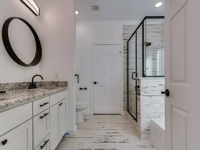 full bathroom featuring vanity, toilet, and independent shower and bath