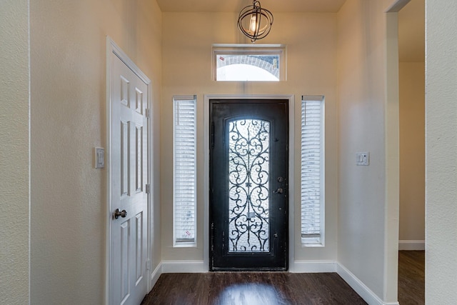 foyer with dark hardwood / wood-style floors